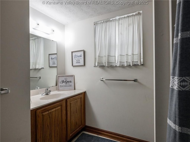 123 Brooke St, Culloden, WV 25510 - bathroom with vanity, a textured ceiling, and baseboards