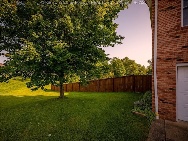 123 Brooke St, Culloden, WV 25510 - yard at dusk featuring a garage
