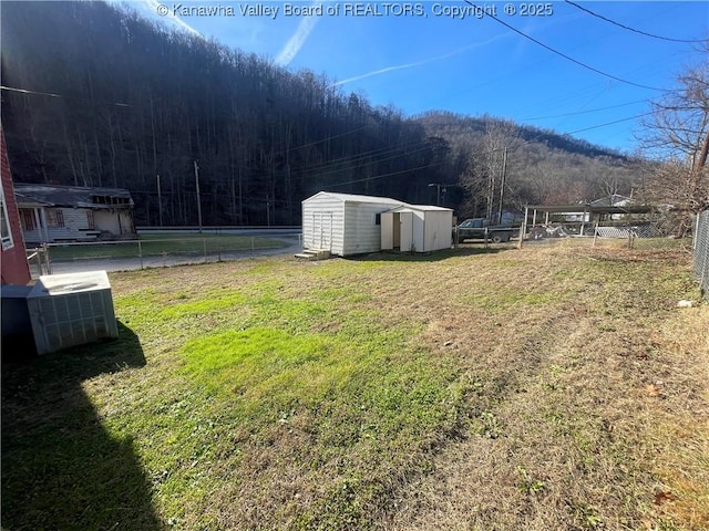 57 Barrett Cir, Wharton, WV 25208 - view of yard with central AC unit, a mountain view, and a view of trees