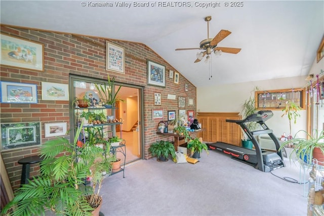 868 Alta Rd, Charleston, WV 25314 - workout area with vaulted ceiling, carpet floors, ceiling fan, brick wall, and a fireplace