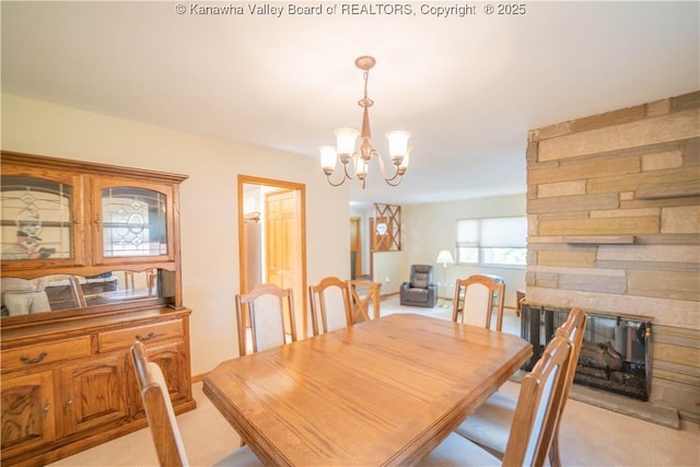 868 Alta Rd, Charleston, WV 25314 - dining area featuring a chandelier, light carpet, and a fireplace