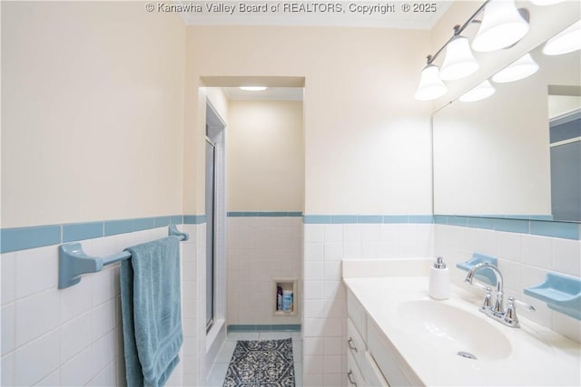 868 Alta Rd, Charleston, WV 25314 - bathroom featuring tile walls, a shower with door, vanity, wainscoting, and tile patterned floors
