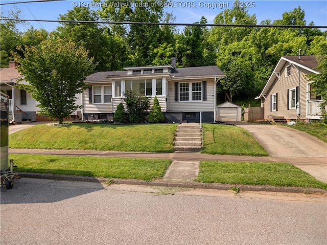 2116 21st St, Nitro, WV 25143 - view of front of home featuring an outbuilding, a front lawn, concrete driveway, and a garage