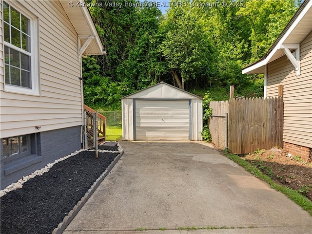 2116 21st St, Nitro, WV 25143 - detached garage featuring driveway and view of scattered trees