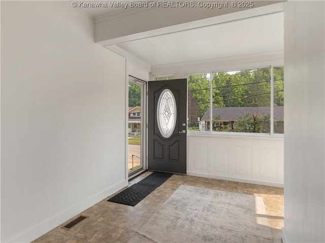2116 21st St, Nitro, WV 25143 - entrance foyer featuring healthy amount of natural light, crown molding, stone finish flooring, and baseboards