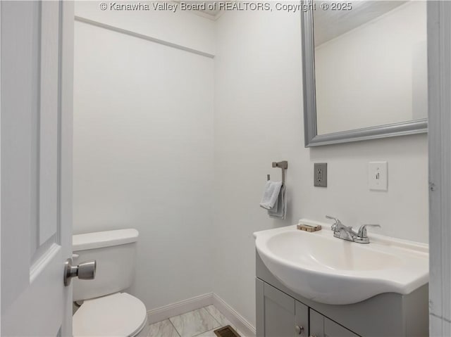2116 21st St, Nitro, WV 25143 - half bath with marble look tile flooring, vanity, toilet, and baseboards