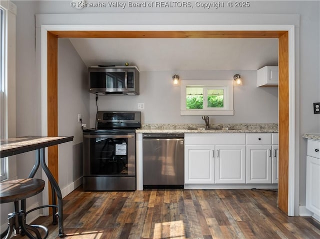 2116 21st St, Nitro, WV 25143 - kitchen with appliances with stainless steel finishes, a sink, white cabinets, and dark wood-type flooring
