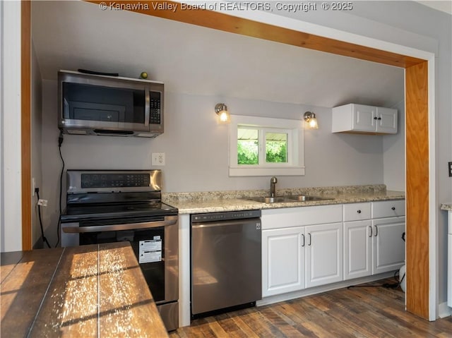 2116 21st St, Nitro, WV 25143 - kitchen featuring stainless steel appliances, a sink, white cabinets, and dark wood-type flooring