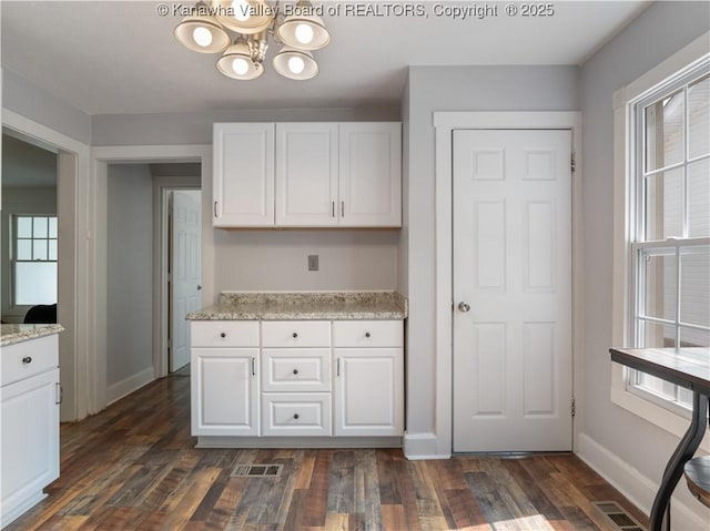 2116 21st St, Nitro, WV 25143 - kitchen with a chandelier, white cabinets, baseboards, and dark wood-style flooring