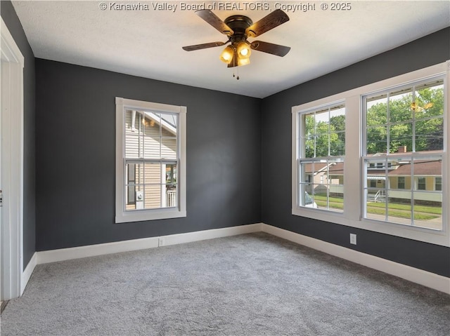 2116 21st St, Nitro, WV 25143 - empty room featuring carpet, baseboards, and ceiling fan