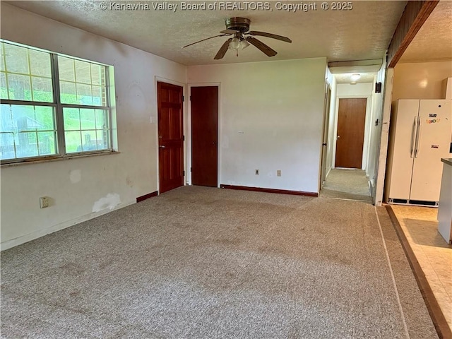 3112 Cicerone Rd, Charleston, WV 25320 - empty room featuring a textured ceiling, a ceiling fan, carpet, and baseboards