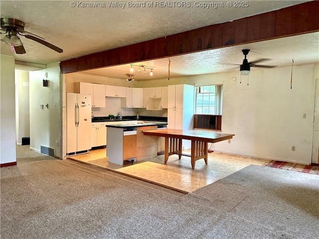 3112 Cicerone Rd, Charleston, WV 25320 - kitchen with freestanding refrigerator, a ceiling fan, a textured ceiling, baseboards, and white cabinetry