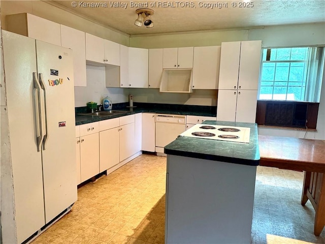 3112 Cicerone Rd, Charleston, WV 25320 - kitchen featuring white appliances, light flooring, a sink, a textured ceiling, and a center island