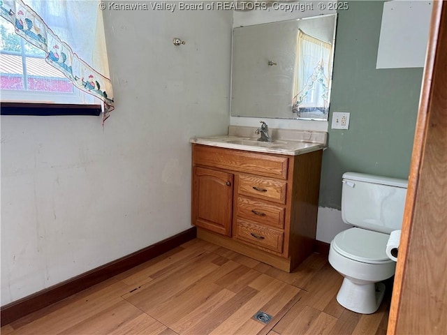 3112 Cicerone Rd, Charleston, WV 25320 - half bathroom with vanity, wood finished floors, toilet, and healthy amount of natural light