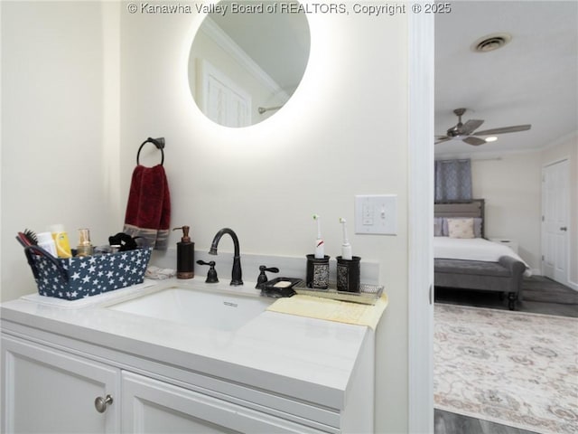 1911 Washington Ave, Saint Albans, WV 25177 - bathroom with vanity, a ceiling fan, wood finished floors, connected bathroom, and crown molding