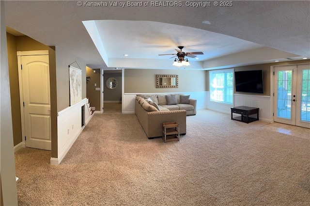 90 Brooke St, Culloden, WV 25510 - living area with a tray ceiling, light colored carpet, a ceiling fan, and french doors
