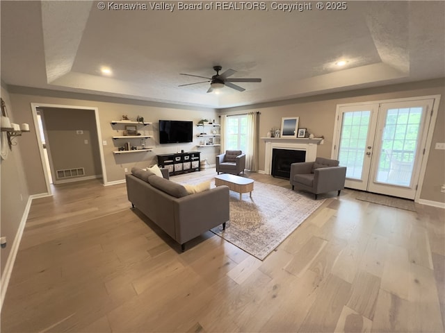 90 Brooke St, Culloden, WV 25510 - living room with a tray ceiling, light wood finished floors, ceiling fan, baseboards, and recessed lighting