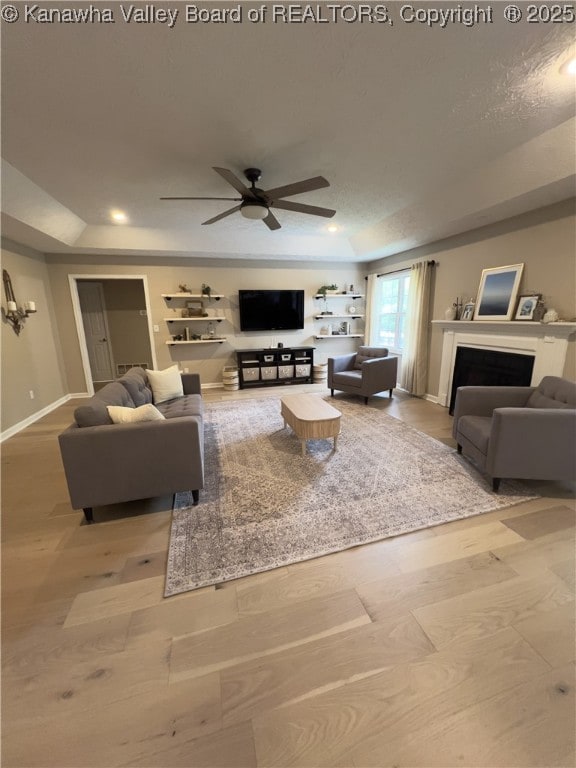 90 Brooke St, Culloden, WV 25510 - living area with a raised ceiling, a ceiling fan, baseboards, a fireplace, and recessed lighting