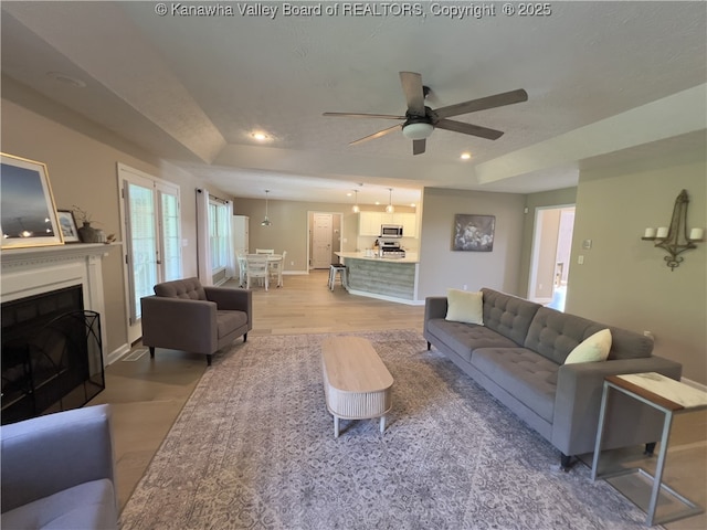 90 Brooke St, Culloden, WV 25510 - living room featuring a raised ceiling, ceiling fan, light wood finished floors, recessed lighting, and baseboards