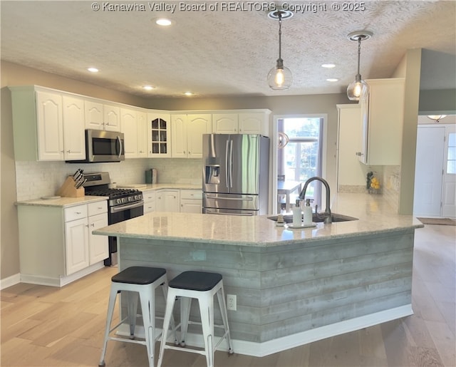 90 Brooke St, Culloden, WV 25510 - kitchen with appliances with stainless steel finishes, a peninsula, light stone countertops, healthy amount of natural light, and recessed lighting