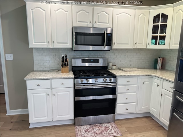 90 Brooke St, Culloden, WV 25510 - kitchen with appliances with stainless steel finishes, light wood-type flooring, and white cabinets