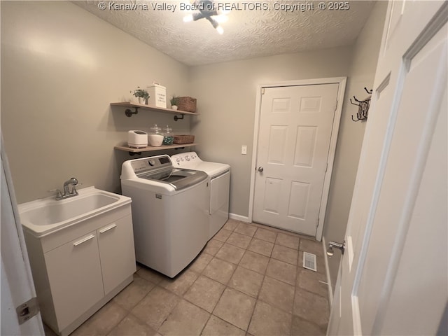 90 Brooke St, Culloden, WV 25510 - laundry room featuring washer and dryer, a textured ceiling, and light tile patterned flooring