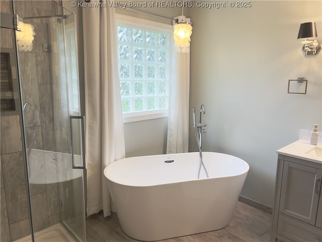 90 Brooke St, Culloden, WV 25510 - full bath featuring a stall shower, a freestanding bath, vanity, and wood finished floors