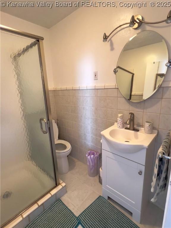 3915 Virginia Ave SE, Charleston, WV 25304 - full bath featuring tile walls, vanity, a shower stall, toilet, and tile patterned floors