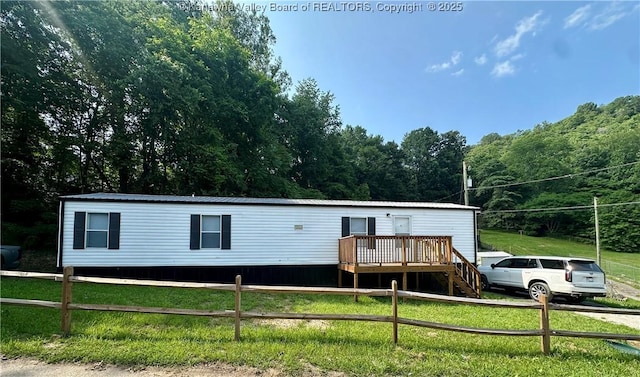 80 Restful Haven Dr, Logan, WV 25601 - manufactured / mobile home with a deck and a forest view
