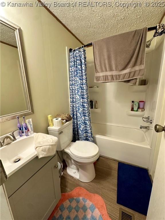 80 Restful Haven Dr, Logan, WV 25601 - bathroom with vanity, wood finished floors, toilet, shower / bathtub combination with curtain, and a textured ceiling
