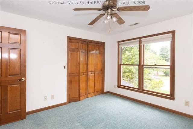 112 Willowood Cir, Hurricane, WV 25526 - unfurnished bedroom with carpet, baseboards, a closet, and ceiling fan