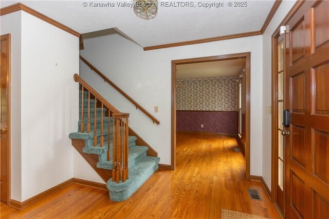 112 Willowood Cir, Hurricane, WV 25526 - foyer with light wood finished floors, stairs, ornamental molding, and baseboards