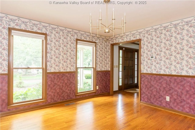 112 Willowood Cir, Hurricane, WV 25526 - unfurnished room featuring a chandelier, wood finished floors, wallpapered walls, wainscoting, and baseboards