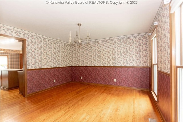 112 Willowood Cir, Hurricane, WV 25526 - unfurnished room featuring wallpapered walls, light wood-type flooring, baseboards, and a chandelier