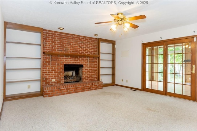 112 Willowood Cir, Hurricane, WV 25526 - unfurnished living room with carpet, a brick fireplace, baseboards, a ceiling fan, and built in shelves