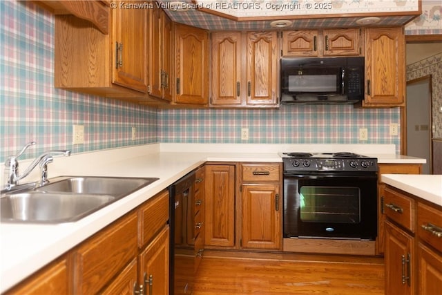 112 Willowood Cir, Hurricane, WV 25526 - kitchen featuring black appliances, a sink, wallpapered walls, light countertops, and brown cabinets