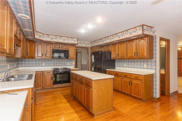 112 Willowood Cir, Hurricane, WV 25526 - kitchen featuring wallpapered walls, black appliances, a sink, light wood-type flooring, and light countertops