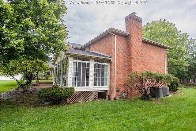 112 Willowood Cir, Hurricane, WV 25526 - view of property exterior with a chimney, a lawn, central AC, and brick siding