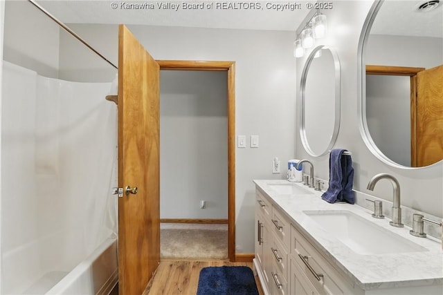 3021 Sansom Ct, Milton, WV 25541 - bathroom with double vanity, wood finished floors, and shower / washtub combination