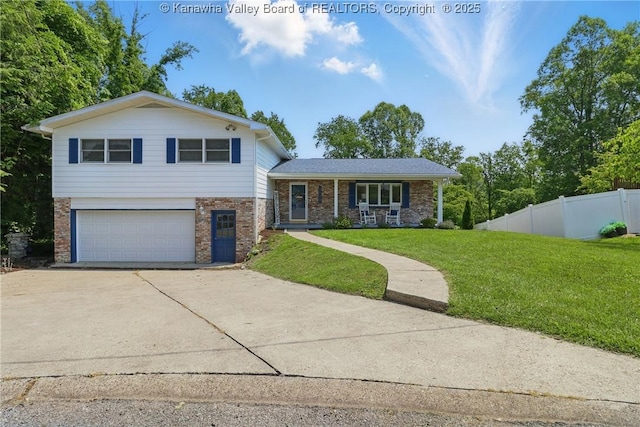 3021 Sansom Ct, Milton, WV 25541 - split level home with brick siding, an attached garage, concrete driveway, and a porch