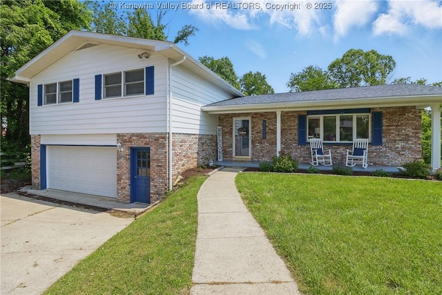 3021 Sansom Ct, Milton, WV 25541 - tri-level home with brick siding, a front lawn, covered porch, concrete driveway, and a garage