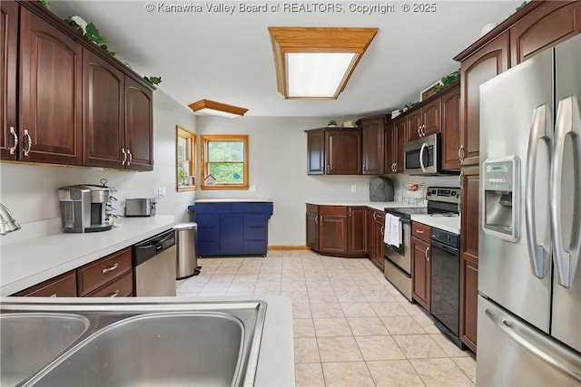 3021 Sansom Ct, Milton, WV 25541 - kitchen with stainless steel appliances, light countertops, a sink, light tile patterned flooring, and dark brown cabinetry