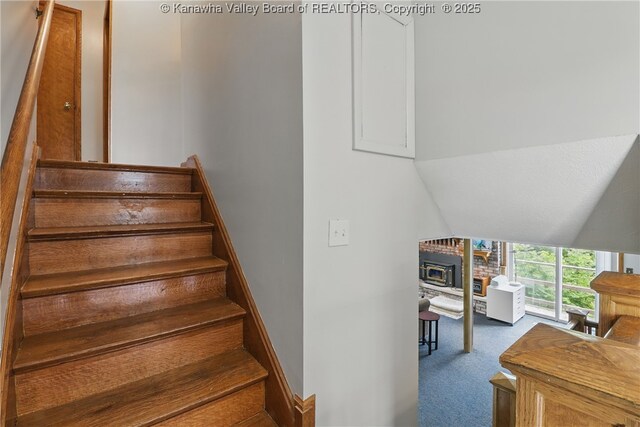 3021 Sansom Ct, Milton, WV 25541 - stairway with carpet flooring, vaulted ceiling, and a wood stove