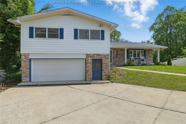 3021 Sansom Ct, Milton, WV 25541 - tri-level home featuring brick siding, concrete driveway, a front yard, and an attached garage