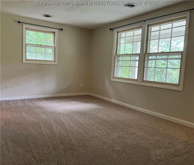 938 Harmony Ln, South Charleston, WV 25303 - unfurnished room featuring healthy amount of natural light, carpet floors, baseboards, and a textured ceiling