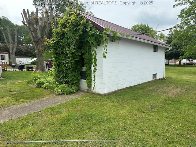 386 Maple St, Mason, WV 25260 - view of home's exterior with a yard and metal roof