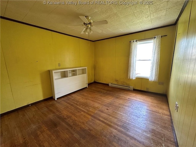 386 Maple St, Mason, WV 25260 - empty room featuring a baseboard radiator, crown molding, ceiling fan, and dark wood-type flooring