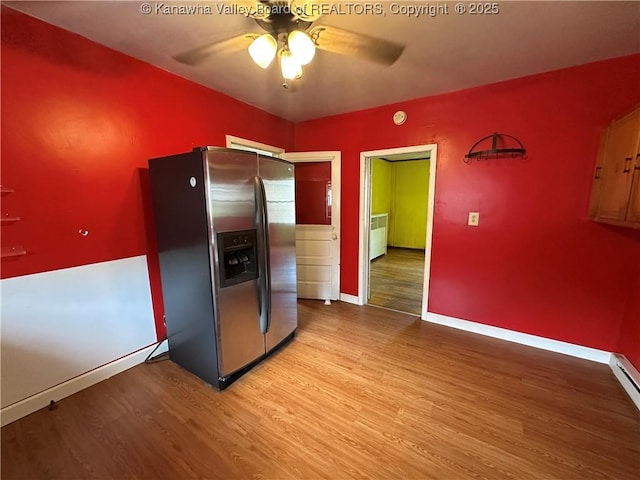 386 Maple St, Mason, WV 25260 - kitchen with stainless steel fridge, wood finished floors, a ceiling fan, and baseboards