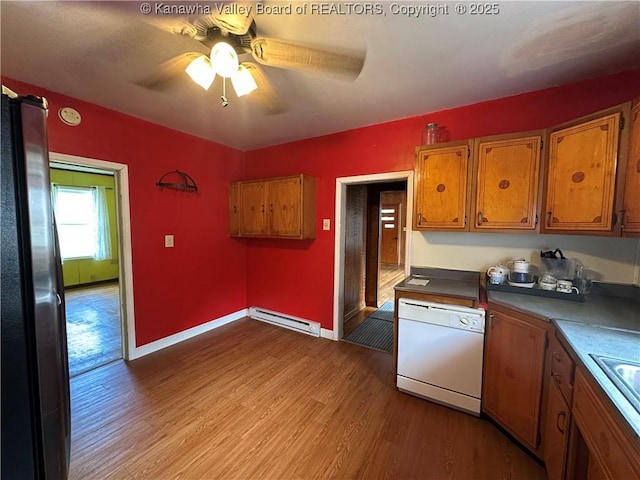 386 Maple St, Mason, WV 25260 - kitchen featuring dishwasher, a baseboard heating unit, freestanding refrigerator, wood finished floors, and brown cabinetry