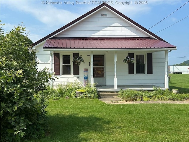 386 Maple St, Mason, WV 25260 - view of front of house with covered porch, a front lawn, and metal roof